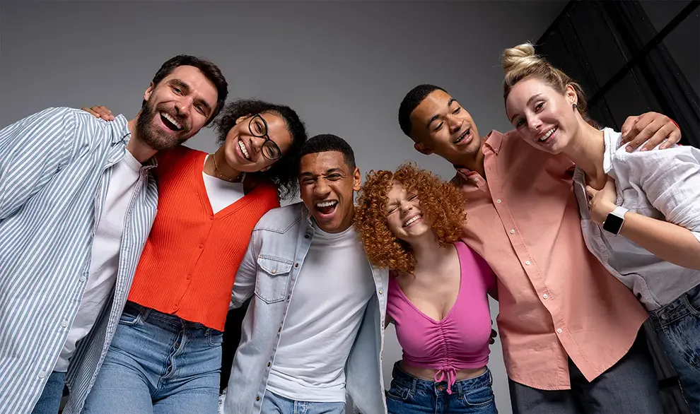 A diverse group of young people laughing together